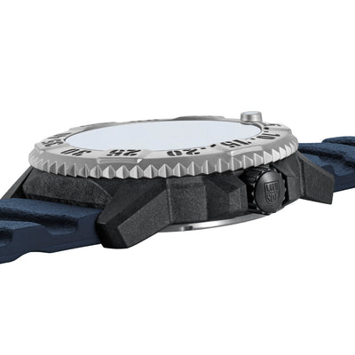 Close-up of a watch with a blue strap and silver bezel on a white background